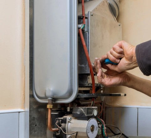 repairman fixing a gas water heater